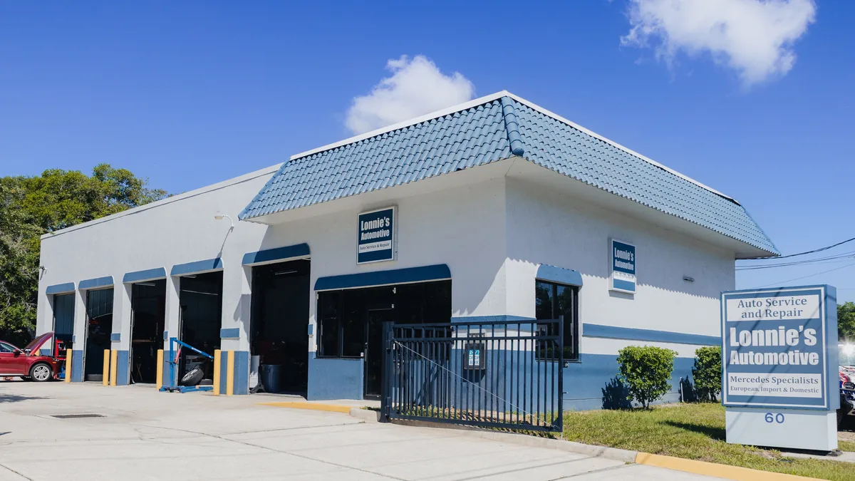 The shop at 60 N Yonge Street, Ormond Beach, with the sign at the road.